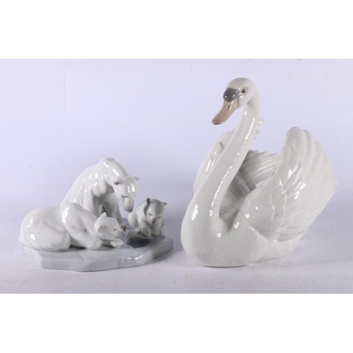 11 - Lladro figurines to include #5123 Swan, #1143 Polar Bear group, a Nao model of a cat, and another.  ... 