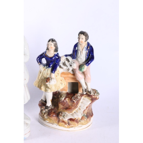 34 - Pottery figurine modelled as a fishwife with creel, 25cm high, another of a dancing couple, and a bo... 