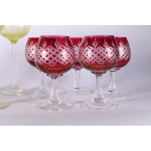 53 - Six uranium style hock glasses, and five cranberry flash-cut wine glasses.