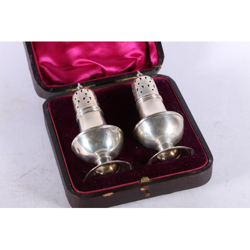 613 - Edward VII cased pair of silver pepperettes hallmarked William Henry Sparrow, Birmingham 1904, 56g.