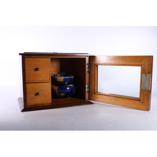 73 - Oak smokers' cabinet, with associated jar.