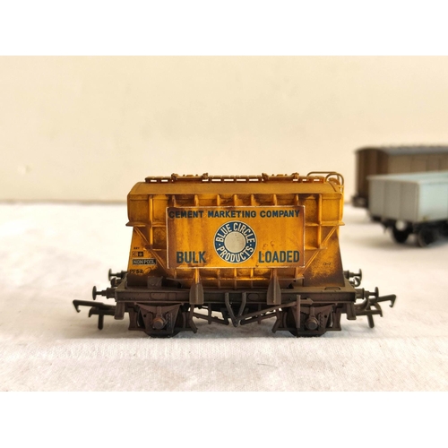 126 - Collection of 00 gauge rolling stock covered goods wagons and trucks, to include examples by Hornby,... 