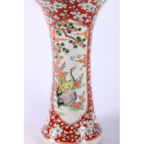 111 - Chinese vase of waisted form with flared rim, two panels on prunus ground, 30cm high.