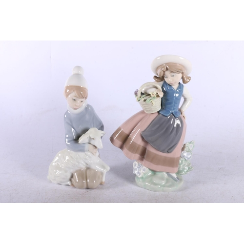 162 - Four Lladro figurines to include Lady with a basket of flowers and a dog, another lady with flowers,... 