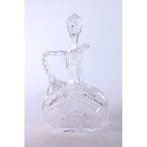 173 - Cut glass and berry and leaf design claret jug with stopper.