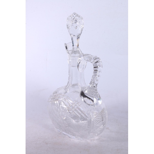 173 - Cut glass and berry and leaf design claret jug with stopper.