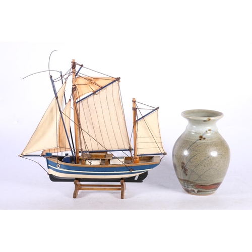 286 - Iona Pottery vase, 16cm and a model boat.