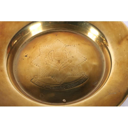 304 - Cheshire Regiment brass dish, another military dish, and a doorknob.