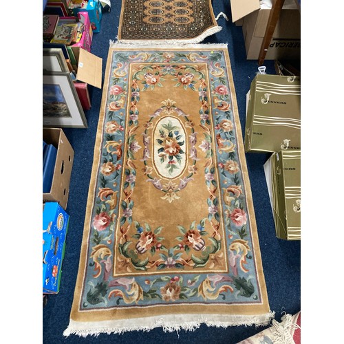 712 - Three Chinese rugs, largest 188cm x 93cm.