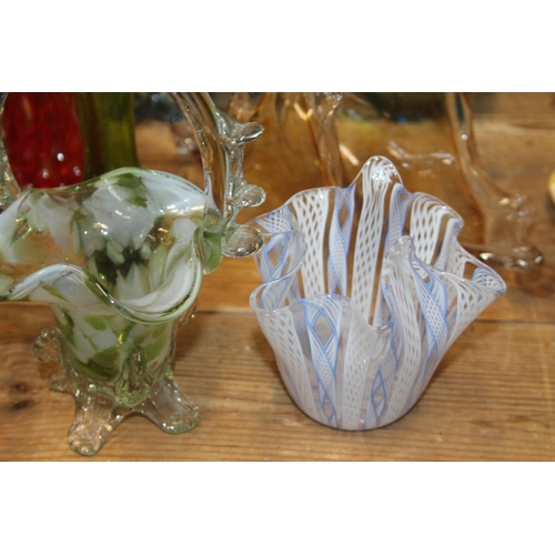 231 - Art Glass to include baskets, an end of day vase, an ashtray, bud vases, and a latticino glass handk... 