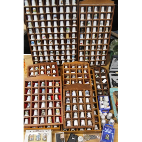 246 - Bone china thimbles held in nine wall racks, and others.