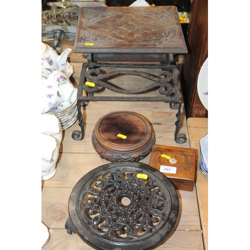 257 - Wrought iron double trivet, a Chinese hardwood stand, a Scottish Arts & Crafts style chip carved... 