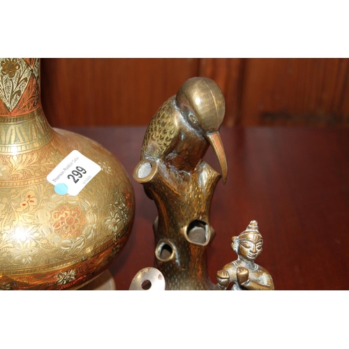 299 - Brass to include a vase, an elephant clock, bell, Southeast Asian deities, etc.