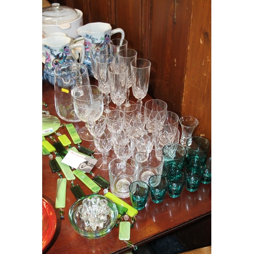 307 - Glass to include champagne flutes, a water jug, a pair of table ornaments, a wind chime, etc.