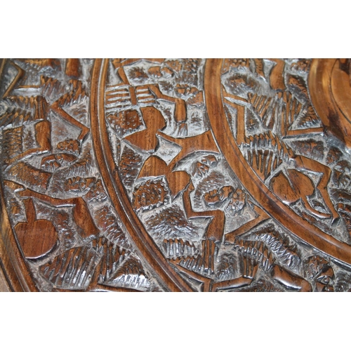 670 - African carved tabletop, 61cm diameter.