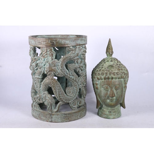 100 - Southeast Asian cast metal deity bust, 23cm high, and a cast metal pierced circular frame.