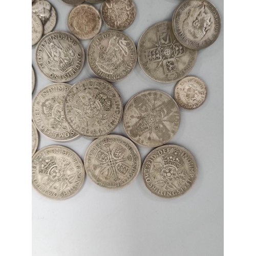 174 - United Kingdom. Large collection of .500 grade silver coins to include shillings, florins and a 1935... 