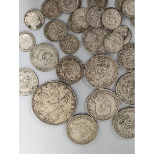 174 - United Kingdom. Large collection of .500 grade silver coins to include shillings, florins and a 1935... 