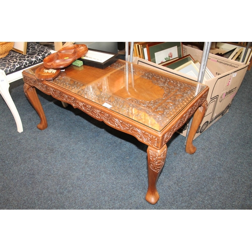 685 - Indian carved table with glass top, 42cm x 93cm x 50cm.