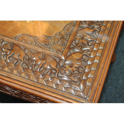 685 - Indian carved table with glass top, 42cm x 93cm x 50cm.