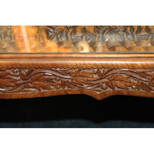 685 - Indian carved table with glass top, 42cm x 93cm x 50cm.