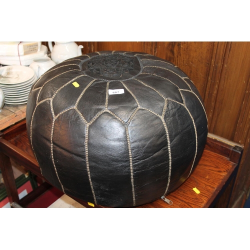 687 - Black leather pouffe, 30cm x 50cm.