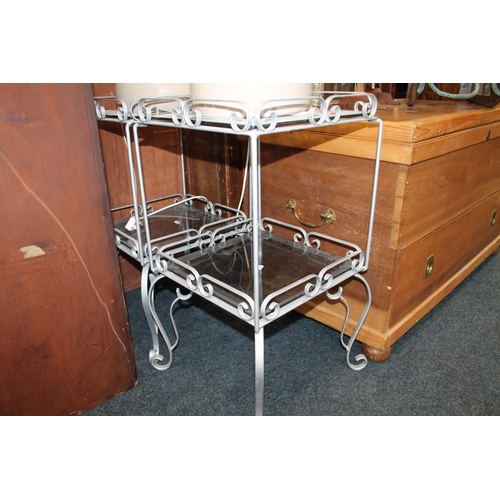 697 - Pair of two tier glass and metal lamp tables, 70cm.