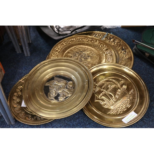 137 - Decorative beaten brass wall plates, largest 52cm.  (8)