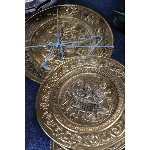 137 - Decorative beaten brass wall plates, largest 52cm.  (8)