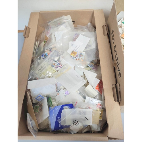 245 - Two boxes containing a large quantity of mixed world postage stamps. (2)