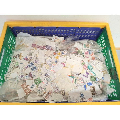 246 - Two boxes containing a large quantity of mixed world postage stamps. (2)