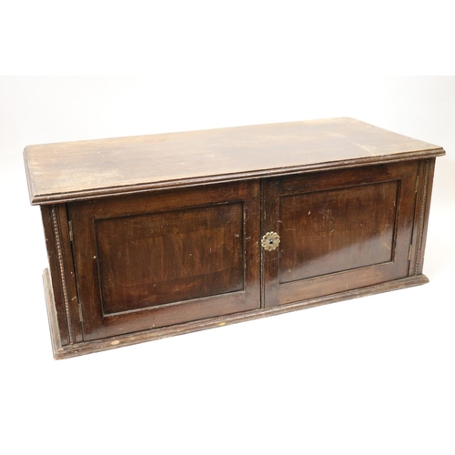 149 - Early 20th century stained pine table box, with two doors to front, 23cm x 60cm x 30cm.