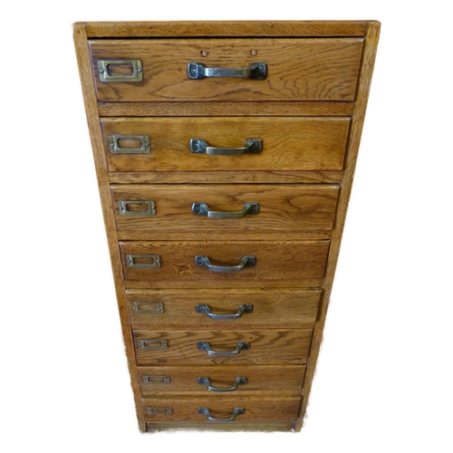 335 - Oak filing cabinet of eight drawers, brass fittings, 104cm high, 46.5cm wide and 37cm deep.