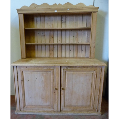 339 - Pine kitchen dresser with shelved Delft rack above a two-door cupboard base enclosing a shelved inte... 