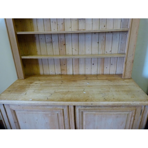 339 - Pine kitchen dresser with shelved Delft rack above a two-door cupboard base enclosing a shelved inte... 