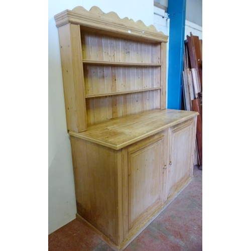 339 - Pine kitchen dresser with shelved Delft rack above a two-door cupboard base enclosing a shelved inte... 