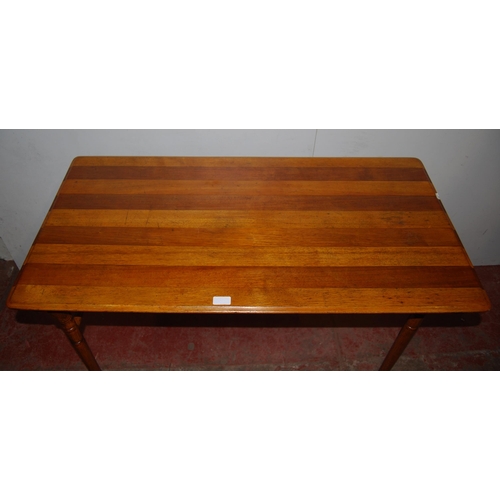 356 - Ash and oak trestle-style folding table, the rectangular top on turned supports and castors united b... 