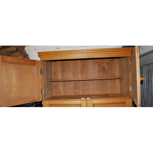 357 - Victorian pitch pine press with two cupboard doors enclosing a shelved interior above two larger doo... 