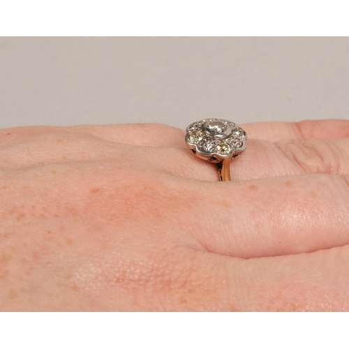 130 - Ladies 18ct yellow gold daisy diamond cluster ring set with a platinum mount, ring size L