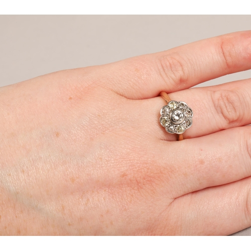 130 - Ladies 18ct yellow gold daisy diamond cluster ring set with a platinum mount, ring size L