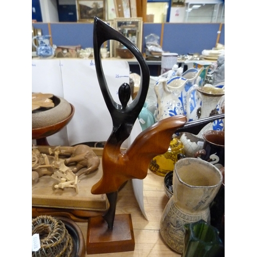 119 - Wood and treen to include candlesticks, bookends, Art Deco-style figure, bowls, stands, spoons, orie... 