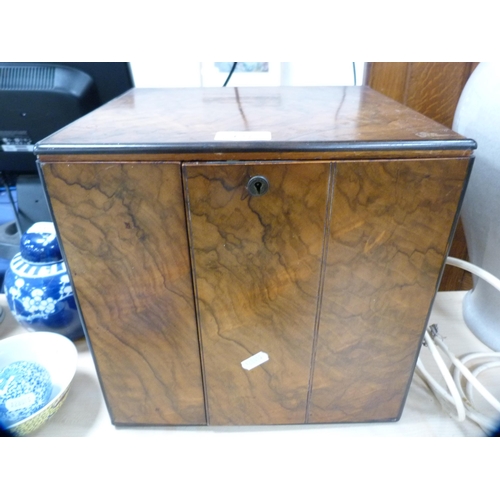 127 - Burr walnut apprentice cabinet with carry handles and doors enclosing fitted drawers.