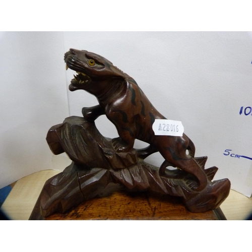 130 - Oriental carved wood animal figure on a wooden stand.