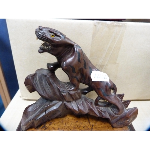 130 - Oriental carved wood animal figure on a wooden stand.