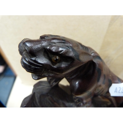 130 - Oriental carved wood animal figure on a wooden stand.