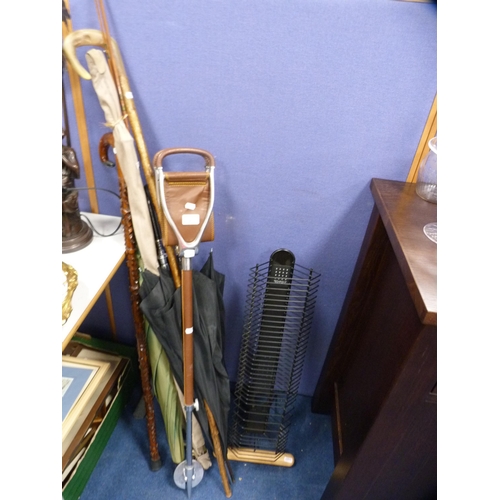 2 - Group of walking sticks to include a shooting stick, also umbrellas, a CD rack and a split cane fish... 