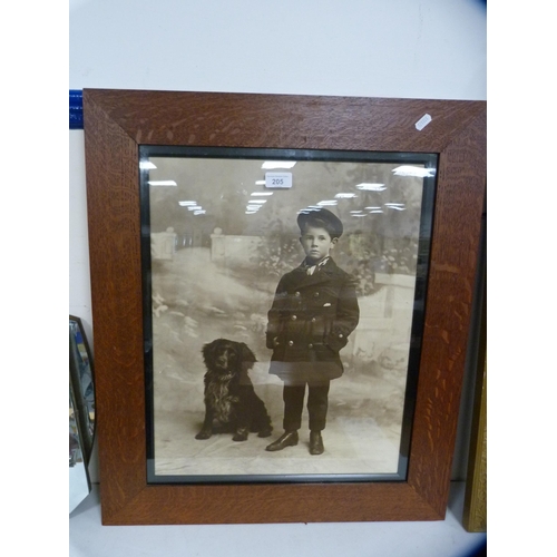 205 - Vintage photograph of a boy and a dog, in an oak frame.