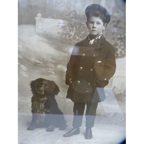 205 - Vintage photograph of a boy and a dog, in an oak frame.