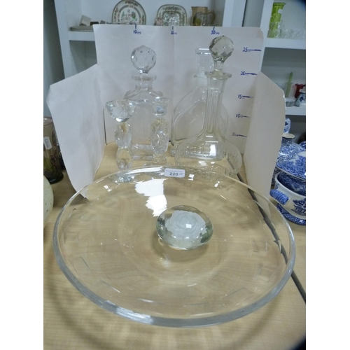 220 - Three glass decanters, cut glass candlesticks, paperweight and a glass dish.