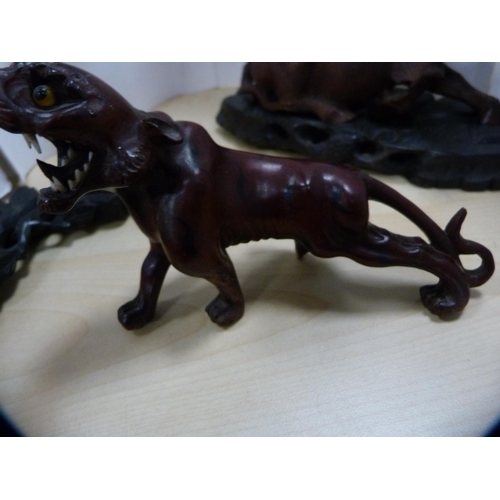 230 - Oriental resin-style figure of a water buffalo and a similar figure of a tiger, both on ebonised sta... 